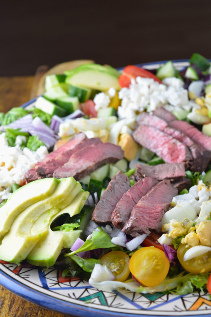 alt="Delicious chopped steak salad with fresh greens and vibrant vegetables"